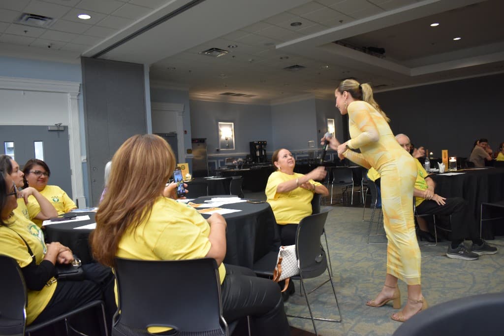 HHI volunteers in yellow shirts interacting with guests at the anniversary celebration