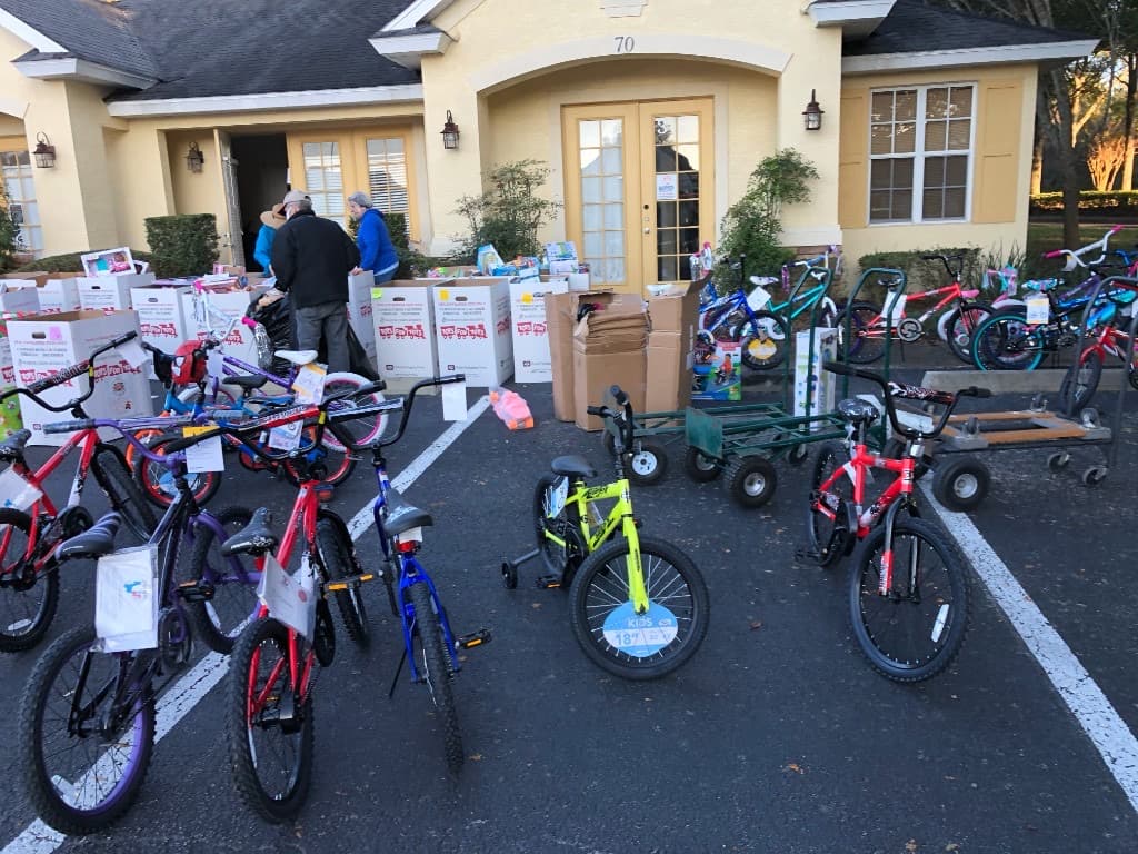 SUV trunk packed with donated toys and bicycles ready for Toys for Tots delivery