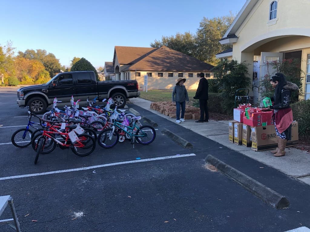 Volunteers in yellow and green shirts organizing toys at the Toys for Tots event