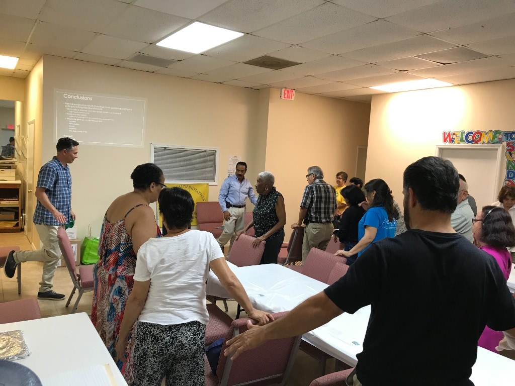 Community members and partners gathered at an HHI health education workshop with a presentation on exercise and physical activity