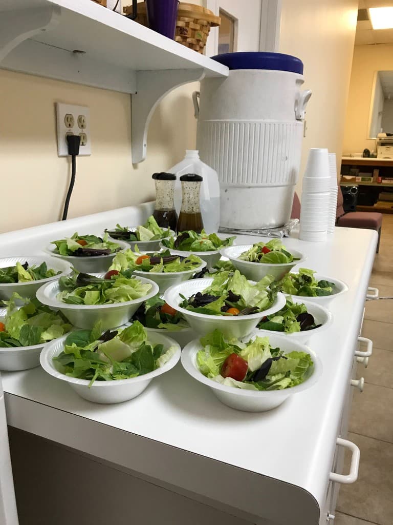 Fresh prepared salads ready for families at an HHI nutrition program